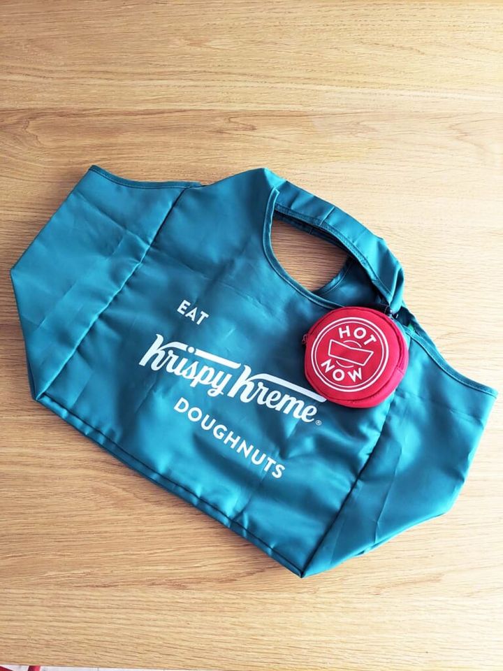 「クリスピー・クリーム オリジナルエコバッグ2024」に「HOT LIGHTポーチ」をカラビナで付けている様子