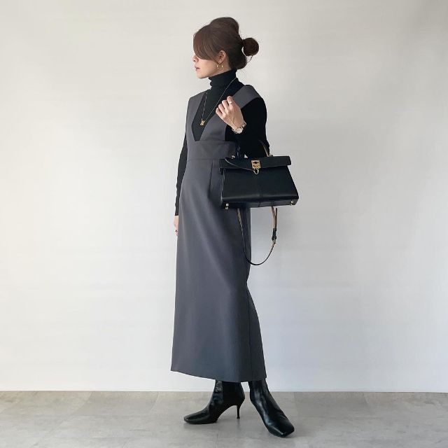 黒のタートルネックニットとグレーのジャンスカの全身コーデ
