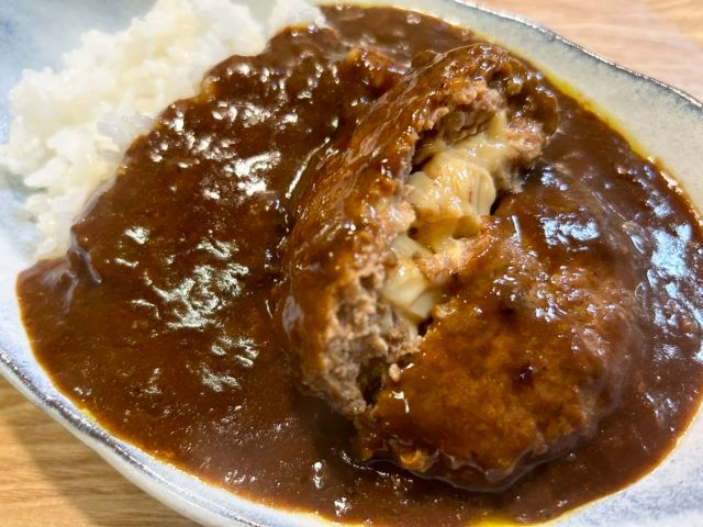 無印ハンバーグカレーのハンバーグからチーズソースが見えている