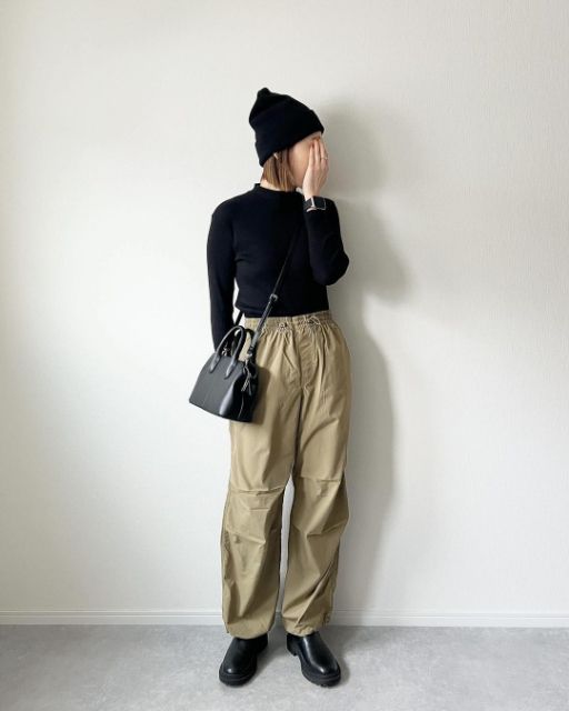 ベージュのパラシュートと黒トップスのコーデ