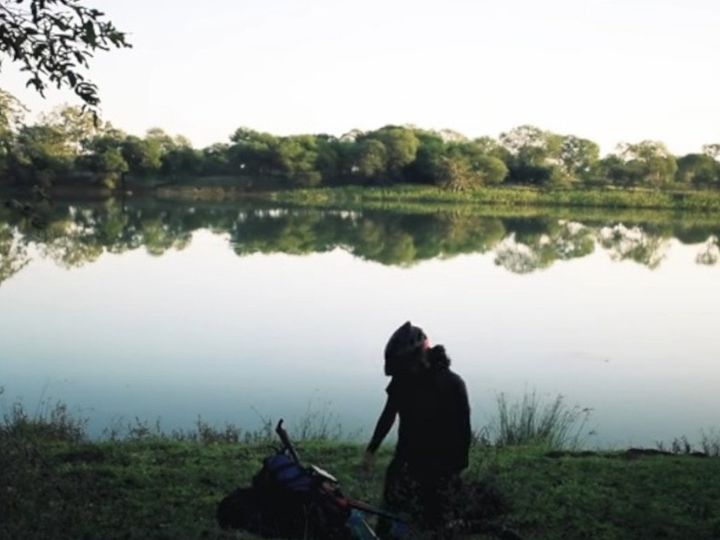 川のほとりでキャンプを楽しむ男性
