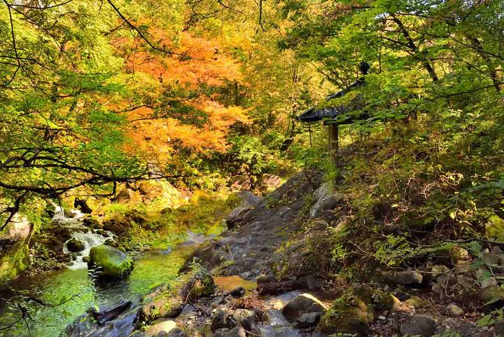 写真右側にあるお堂が霊庇閣。対岸上流の岩肌に「カンマン」の梵字がある