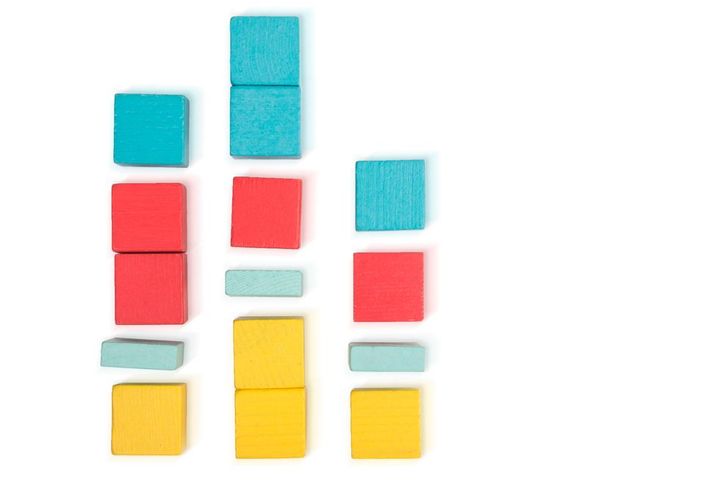 toy wooden blocks as financial graph graph with four 4 steps growing chart infographic diagram, chart over grey or black or dark background multi colored wooden blocks