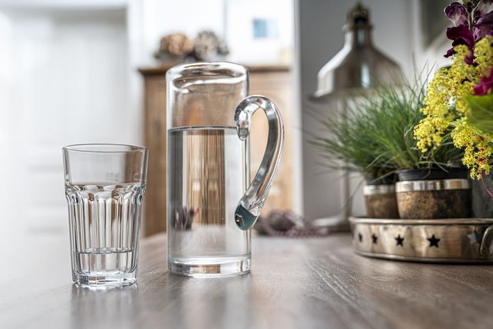 water glass with carafe on a kitchen table in a kitchen