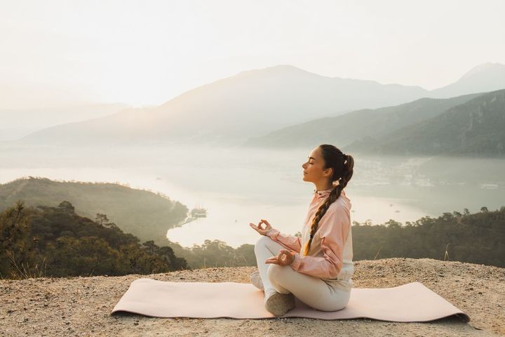 young woman practicing yoga and meditating life balance and harmony with nature