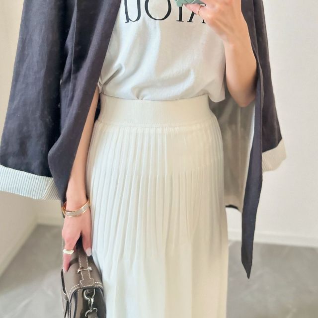 白のGUのシアーニットフレアスカートを着用