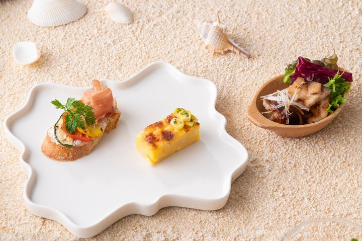 「生ハムと夏野菜のオープンサンド」（写真プレート左）「とうもろこしのパウンドケーキ “ソパ・パラグアージャ”」「三元豚のサムギョプサル」