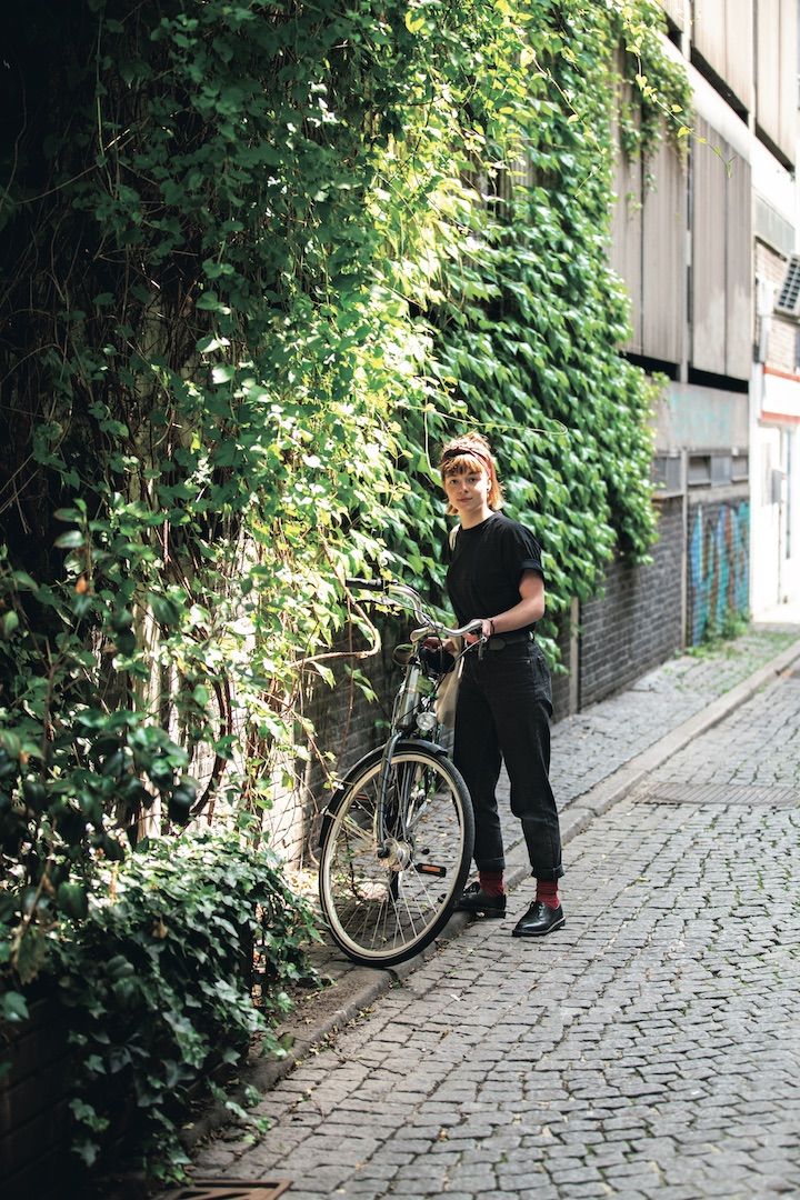 オールブラックコーデの中にちらりと見える差し色のワインレッドが効いているコーデ