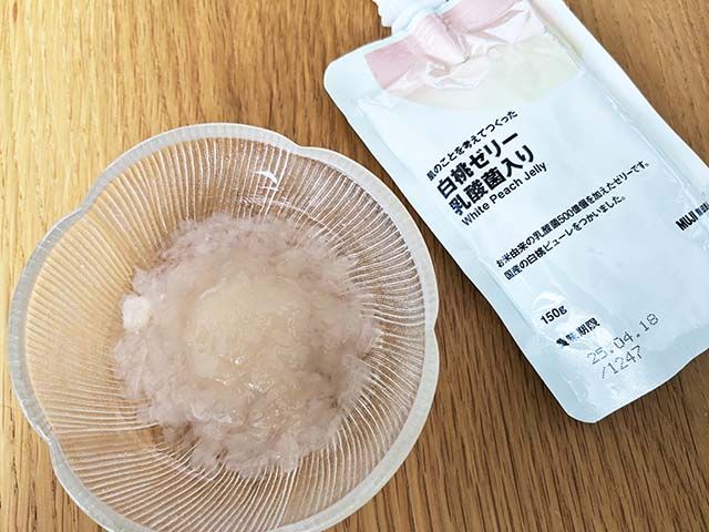 無印良品「肌のことを考えてつくった 白桃ゼリー 乳酸菌入り」のパッケージと、器に入れられたゼリーがテーブルに並んでいる様子