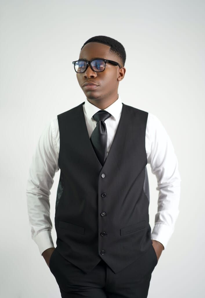 a man in a suit and sunglasses posing for a picture