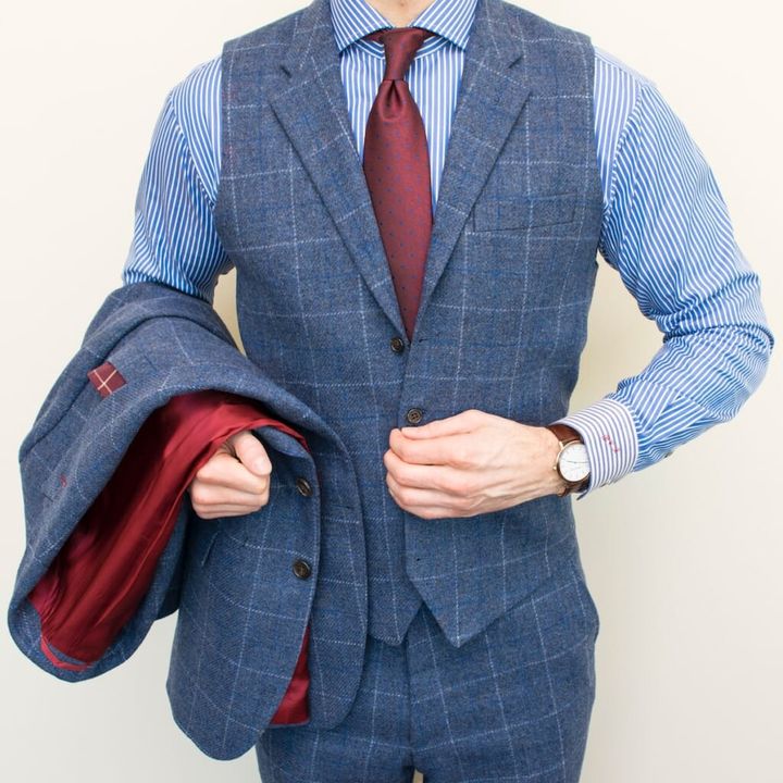 man in blue and gray pinstripe suit jacket