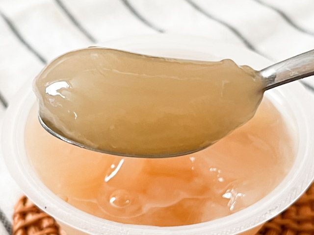 スプーンですくったフルーツのジュレ白桃