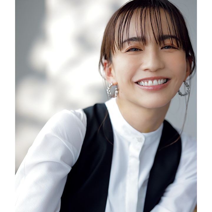 スタンドカラーブラウスを着用の優木まおみさんが笑顔の写真