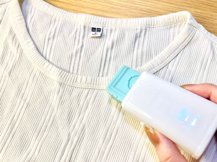 ダイソー「エリ・そで洗濯せっけん」のケースにカットしたウタマロ石けんをセットし、手に持ってTシャツの襟周り汚れを落としている画像