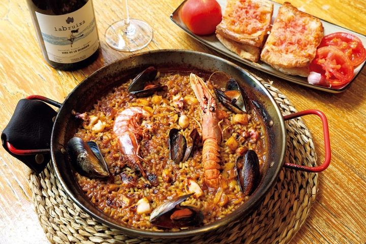 【L’ARROSSERIA XÀTIVA アロセリア・シャティバ】イカやムール貝、海老などが入った魚介のパエーリャ€20.5（1人前）とパンにニンニクとトマトをこすりつけて食べる「パンコントマテ」3€。