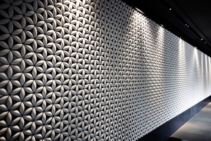 日本古来の七宝柄をあしらった白い陶器の壁。モダンなインテリアと和の伝統美が融合。 