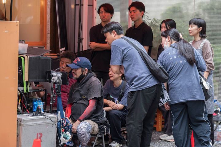 「孤独のグルメ」Tシャツを着たスタッフたちは、店外から演技を見守ります。