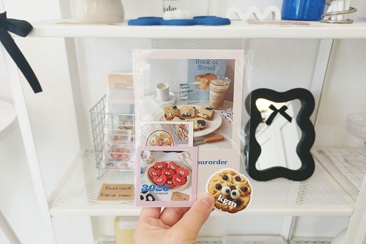 （写真左から）「ポストカード」400円、「ステッカー」300円