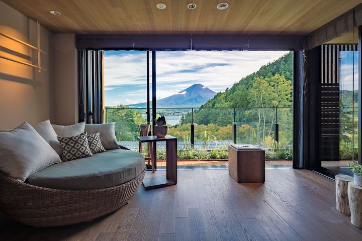 4階「梢プレシャススイート」からの眺め。木立の間に輝く河口湖と、その向こうで季節ごとに表情を変える富士を見ることができる。