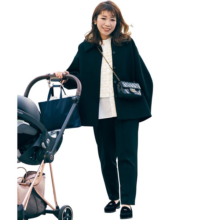 白の甘ブラウスに黒パンツとアウターと小物を合わせたベビーカーを押すママ