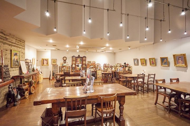 アンティークのテーブルや椅子が置かれた店内