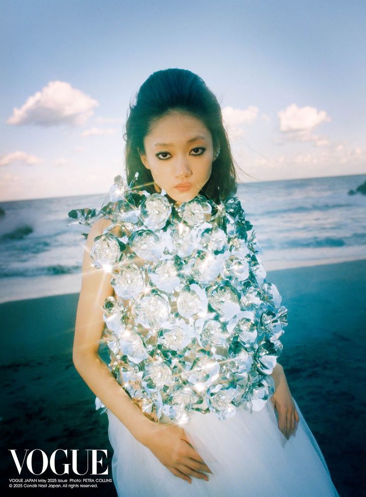Wrapped in light<br /> Mona wears a striking top adorned with reflective silver flowers by Noir Kei Ninomiya.