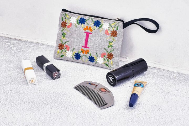 「シャネル」のkabukiブラシとリップクリーム（白）、口紅（黒）。ラブクロムのくし。ロクシタンの爪オイル。