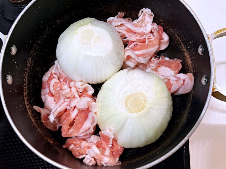 新玉ねぎと豚バラ肉を鍋に入れる