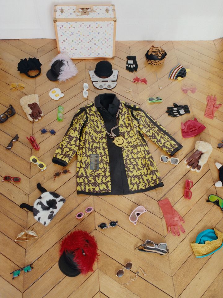 ｢ルイ･ヴィトン×村上隆｣コレクションのトランク（写真上、ルイ・ヴィトン、2003年春夏）と、「ルイ・ヴィトン×スティーブン・スプラウス」コレクションのジャケット（中央、ルイ・ヴィトン、2001年春夏）、周囲を取りまく小物は複数のブランド。