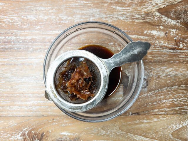 小鍋に醤油・みりんを入れて火にかけ、アルコールを飛ばしたら鰹節を加えて火を止め、裏ごしする。