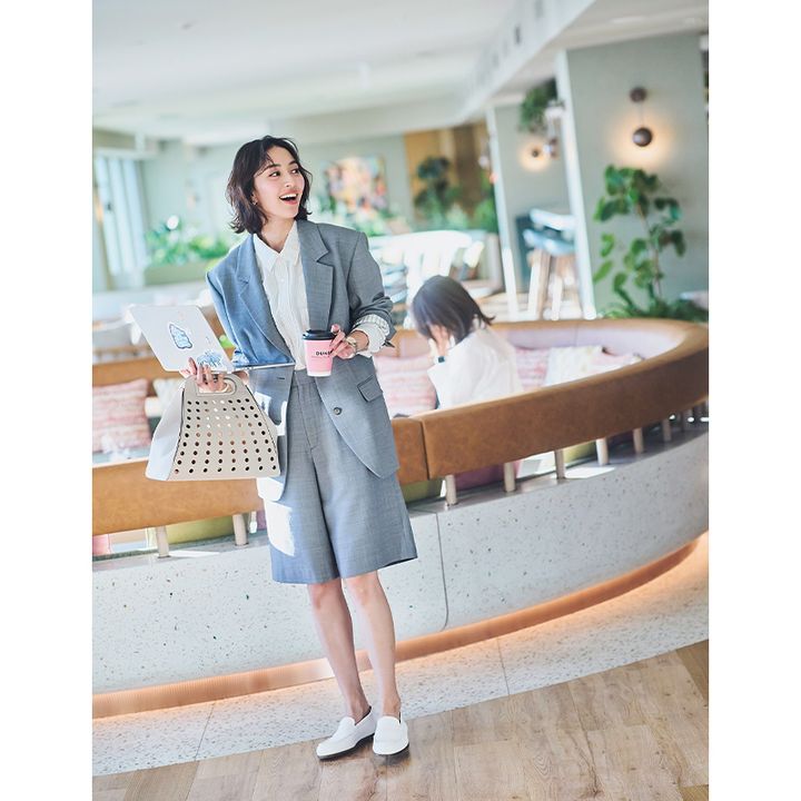 グレーのハーフパンツセットアップにストライプシャツをインして白のバッグとローファーを合わせたオフィスコーデ