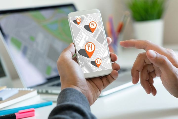 スマートフォンでレストランショップを検索する人