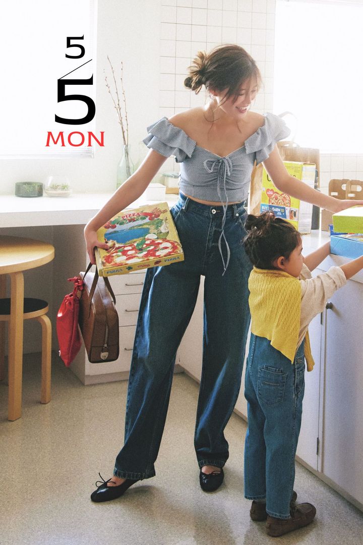 袖がフリルになっていて胸元にリボンがついたスイムウェアにゆるっとしたデニムとボストンバッグやバレエシューズを合わせた着こなし