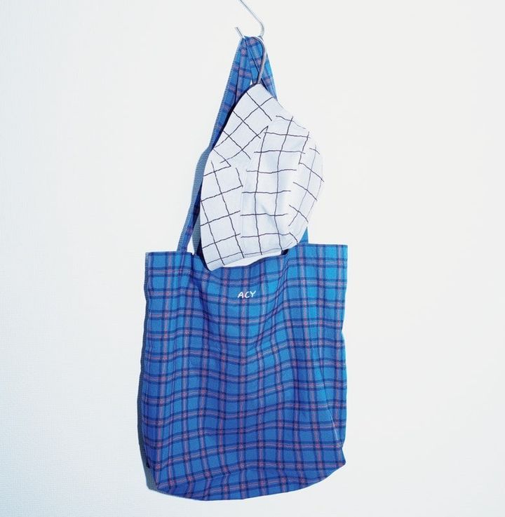 エイシーの、くたっとした生地感と手描きしたように波打ったラインが印象的のトートバッグとハット