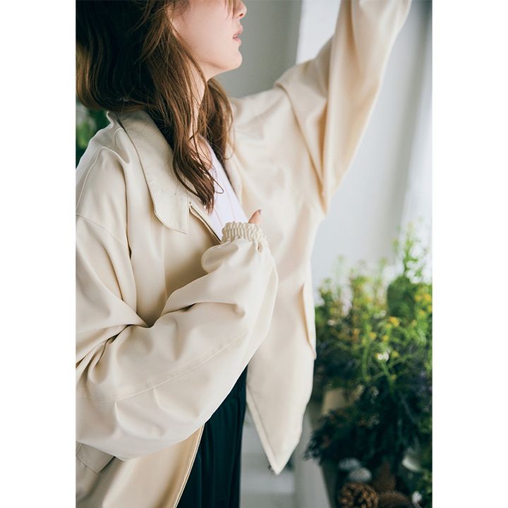 白Tシャツにベージュのジャケットを羽織ったコーデ