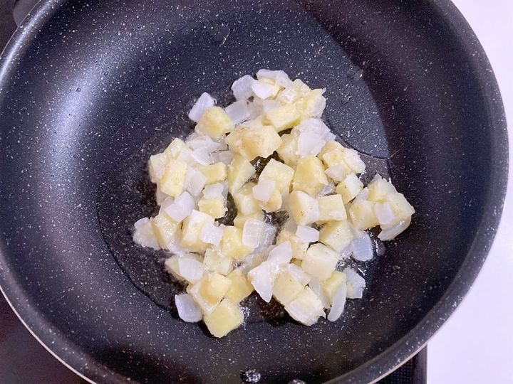 油を熱したフライパンにじゃがいもと玉ねぎを入れる