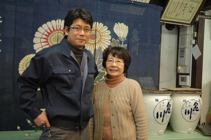 酒蔵の売店で微笑む9代目蔵元・廣木健司さん（撮影時42歳）と母・浩江さん