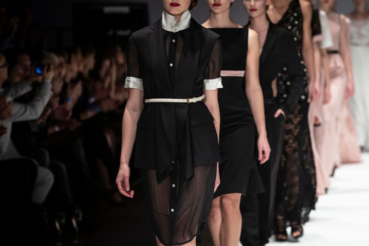 ファッションショーでランウェイを歩く女性たち