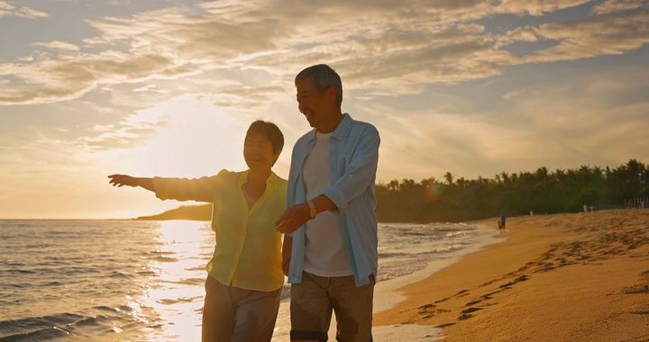 海岸沿いを歩く夫婦