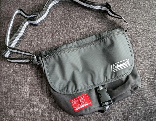 スヌーピー×コールマン メッセンジャーバッグの全体像。グレー基調にColemanロゴと赤タグがポイント