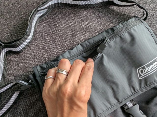 フラップ上部のファスナーポケットを開ける様子