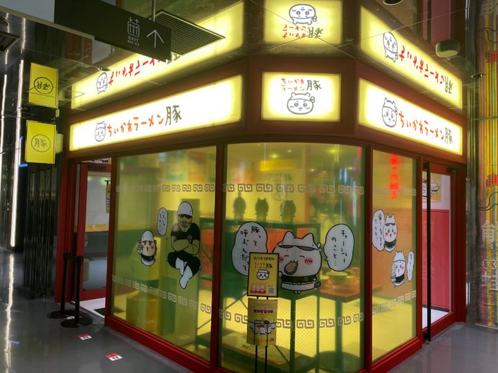 おしゃれなレストランフロアの中、ひときわ目立つ黄色い看板