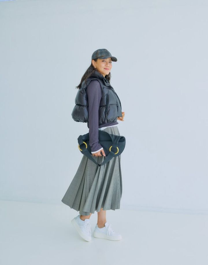 スカート¥57,200／ソブ（フィルム）、ダウンベスト¥42,900／ル フィル（ル フィル ニュウマン新宿）、カットソー2枚セット¥8,990／プラステ、バッグ¥198,000／J&M デヴィッドソン（J＆M デヴィッドソン カスタマーセンター）、スニーカー¥39,600／デイト（ティースクエア プレスルーム）、キャップ¥52,800／ボルサリーノ（中央帽子）、ピアス¥16,500／ワンエーアールバイウノアエレ（ウノアエレ ジャパン）、 YGリング¥726,000、ラピスラズリリング ¥411,400／ともにマリハ