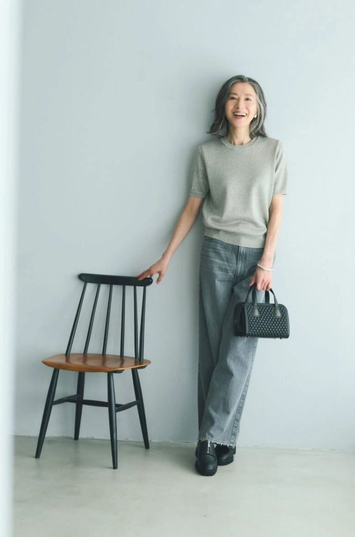 デニムパンツ¥28,600／アッパーハイツ（ゲストリスト）、ニット¥25,300／エブール（リトルリーグ インク）、バッグ¥253,000／ティッサ・フォンタネダ（アッシュ・ペー・フランス）、イヤリング¥5,670／アビステ、ブレスレット¥7,700／ピルグリム（ズットホリック）靴¥27,500／ヒミコ