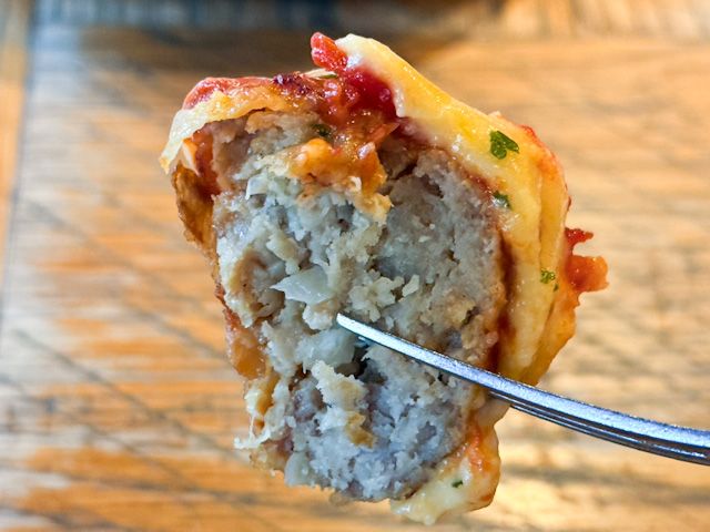 フォークで持ち上げた「成城石井自家製 3種チーズの国産豚肉団子」