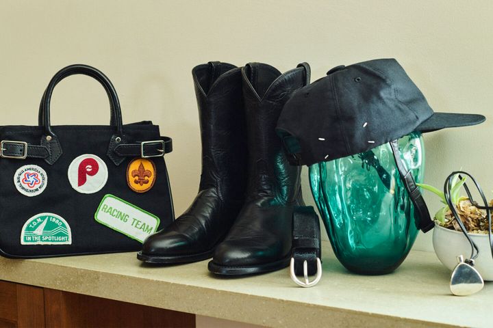 バッグ（HERITAGE LEATHER）、ブーツ（LUCCHESE）、キャップ（MAISON MARGIELA）、ネックレス（VINTAGE HERMES）