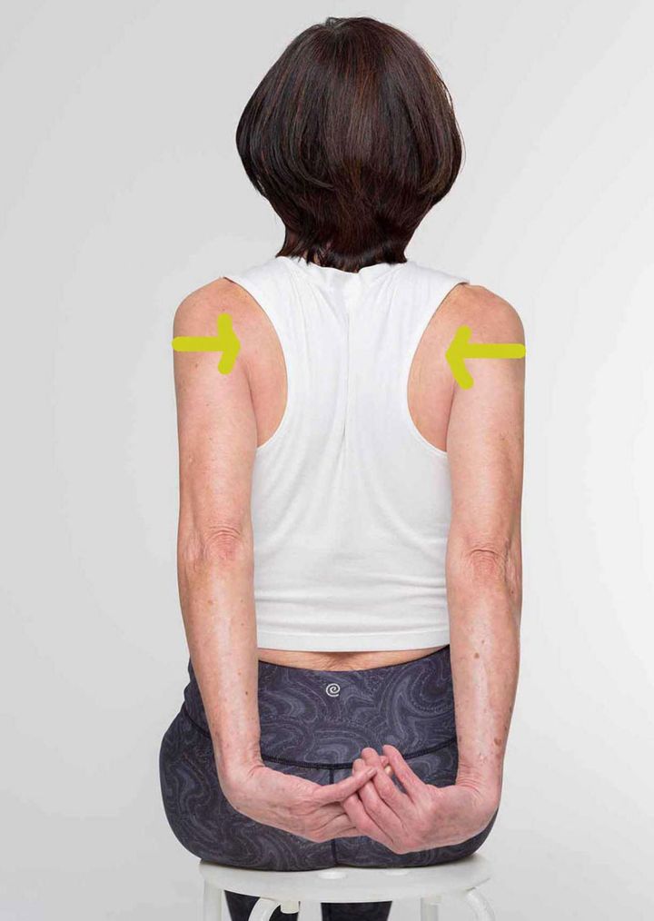 【３】肩甲骨を寄せながら、組んだ手を上げて、10秒キープします。