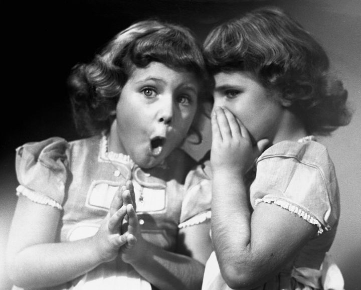 UNITED STATES - CIRCA 1950s_ Twin sisters sharing secrets. (Photo by George Marks/Retrofile/Getty Images)