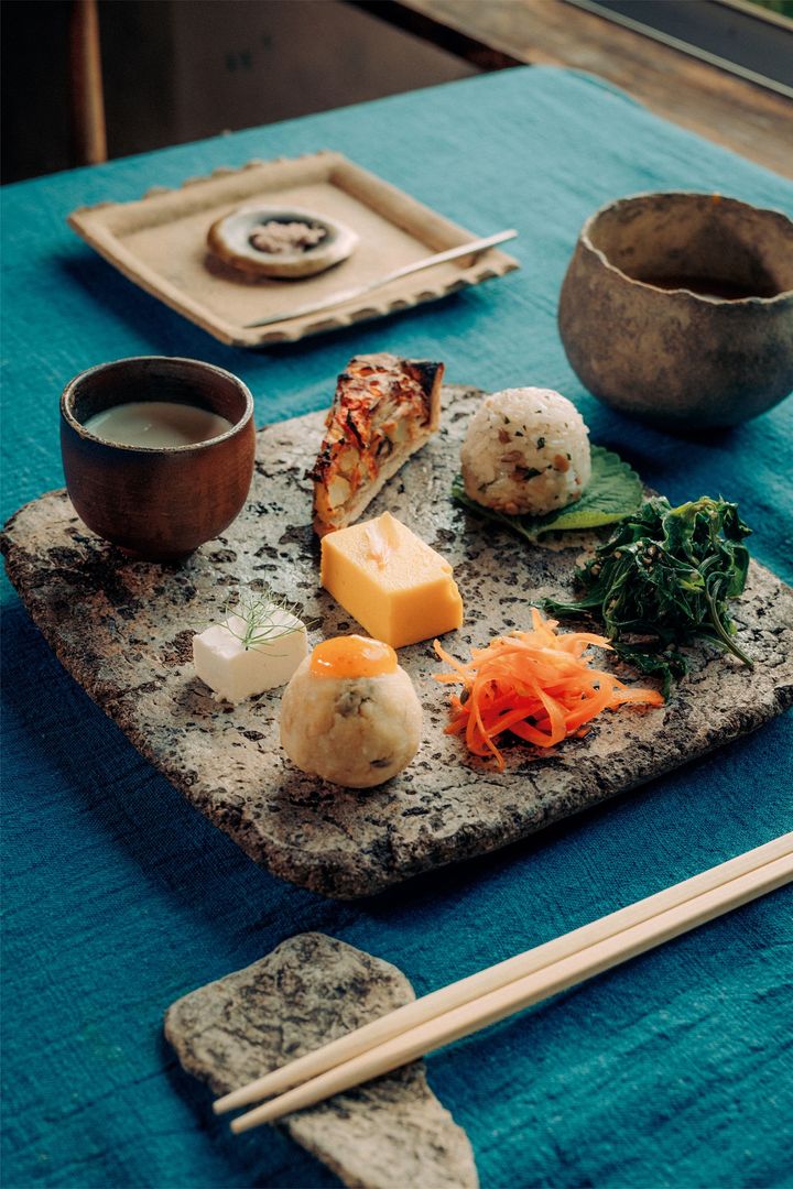 ツルムラサキの和えもの、胡麻の葉にのせた一口サイズのおにぎりなどが並ぶ前菜。