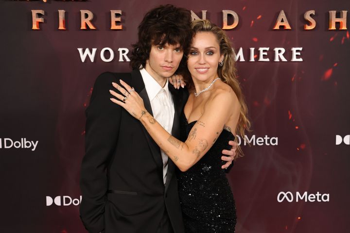 HOLLYWOOD, CALIFORNIA - DECEMBER 01_ (L-R) Maxx Morando and Miley Cyrus attend the Global Premiere of 20th Century Studios' 